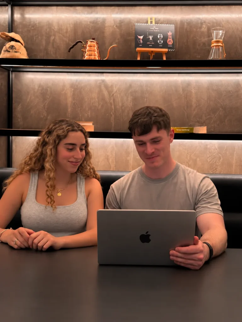 Lily and Dan, co-founders of The Social Bay, at a laptop